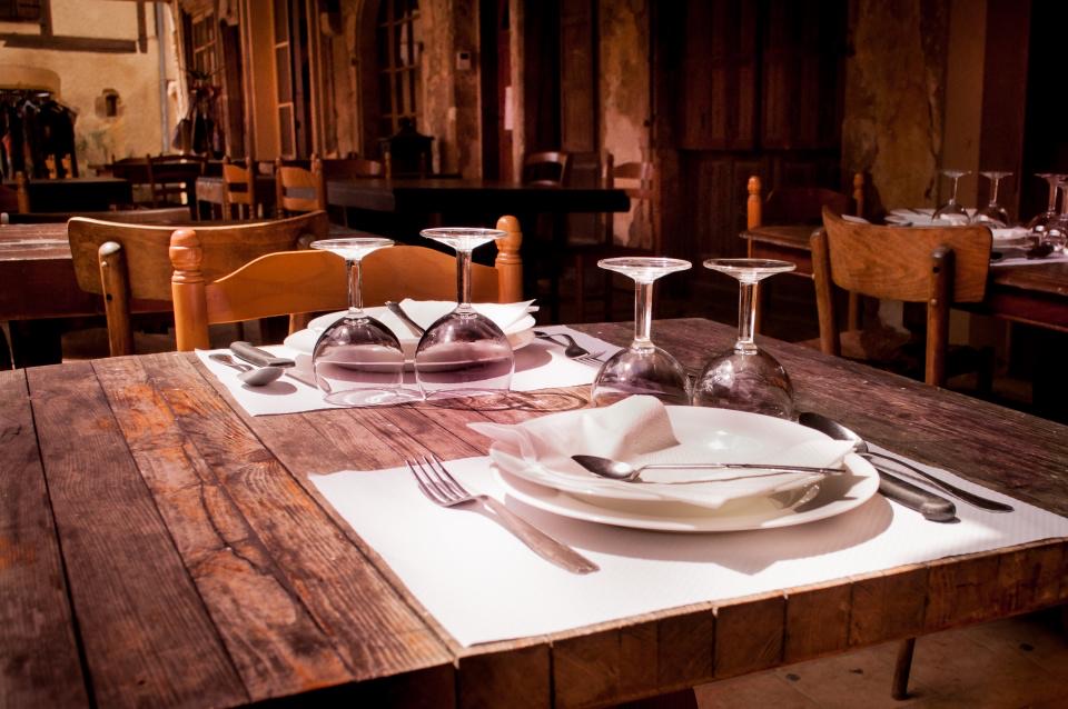 Rustic wooden dining tables set for dinner