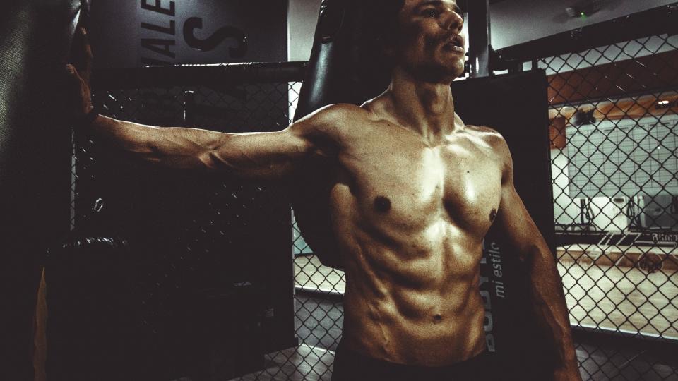 Athlete training in a dark gym
