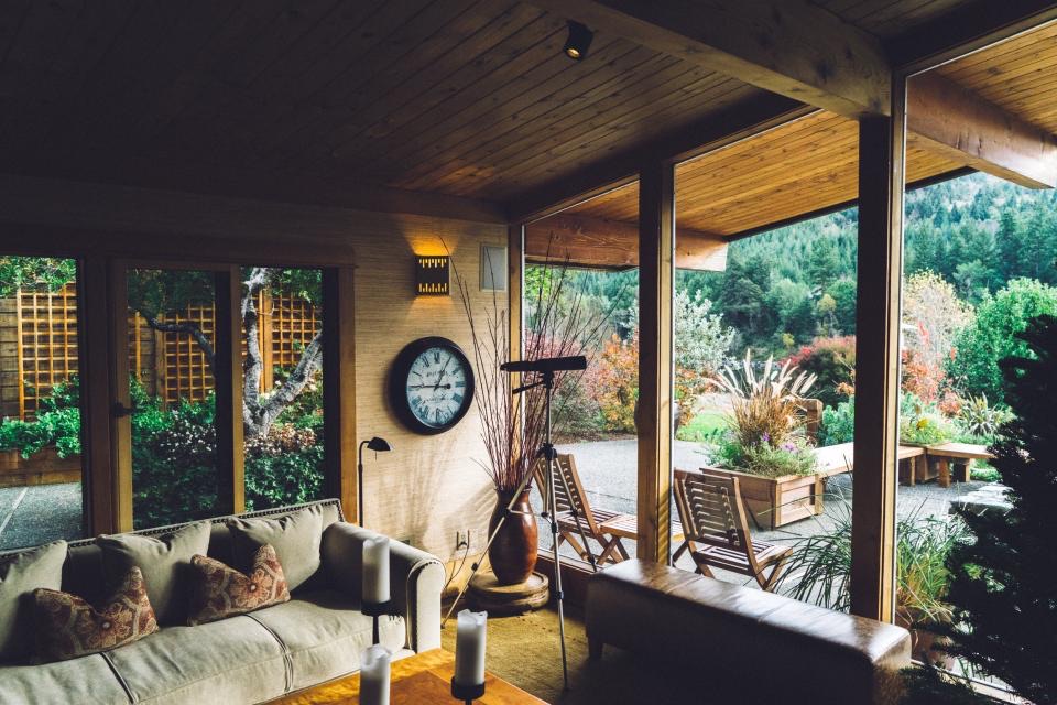 Covered patio living space opening to a garden